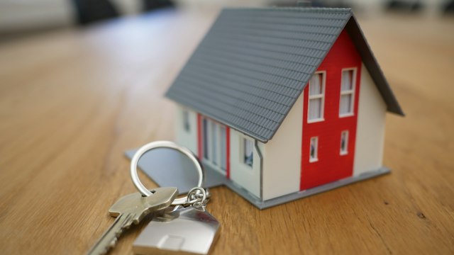 House keys on property ownership documentation for home affordability